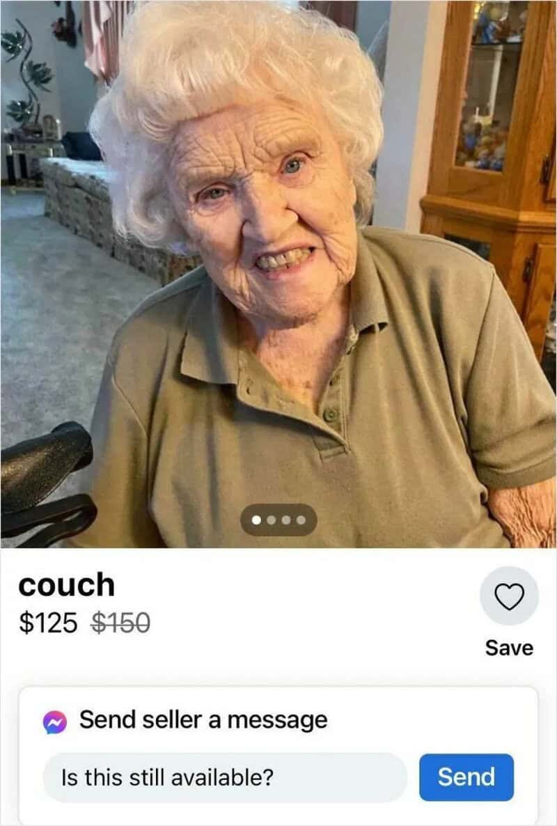 Elderly woman with white hair smiling, sitting on a couch in a home.