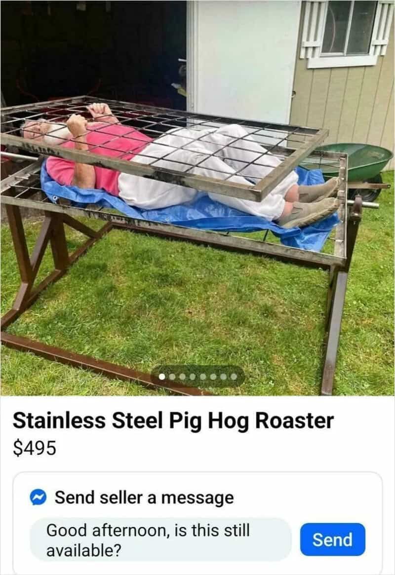 Person lying on a stainless steel pig hog roaster with a pink shirt and white blanket.