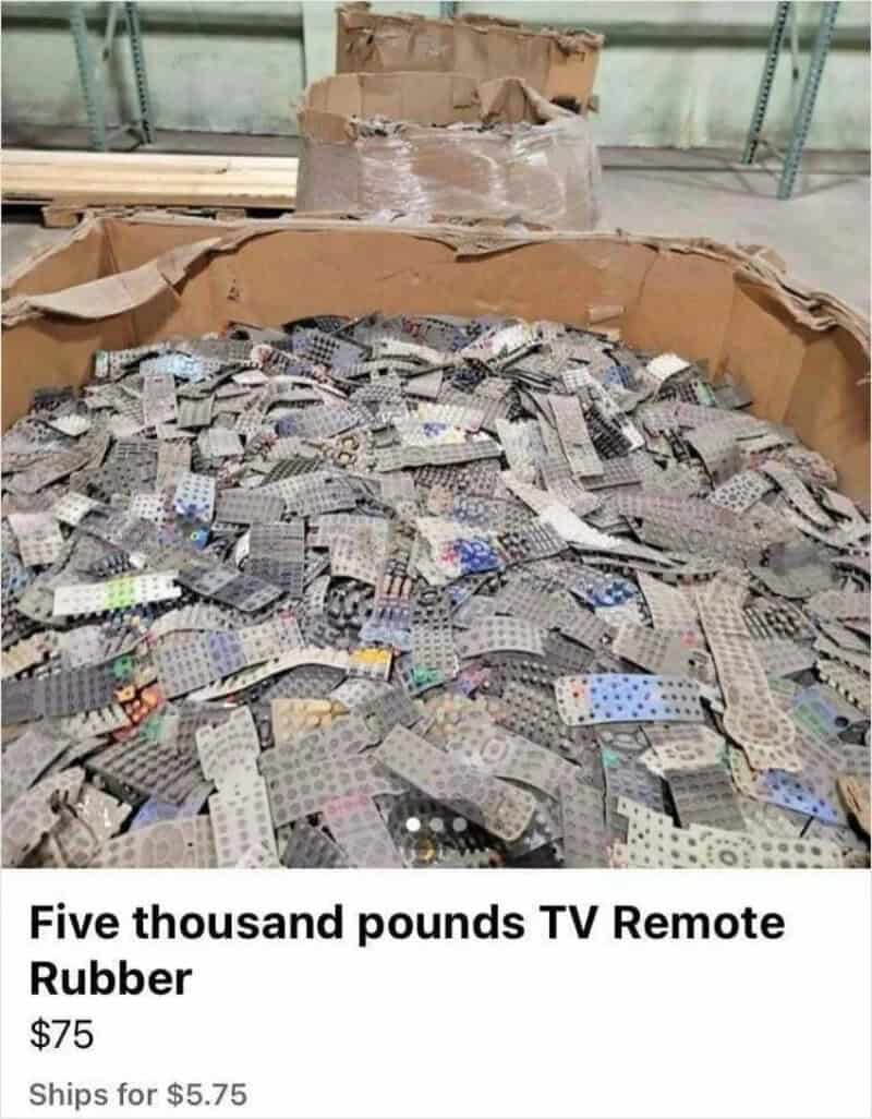 Large box filled with TV remote rubber pieces, some in a pile.