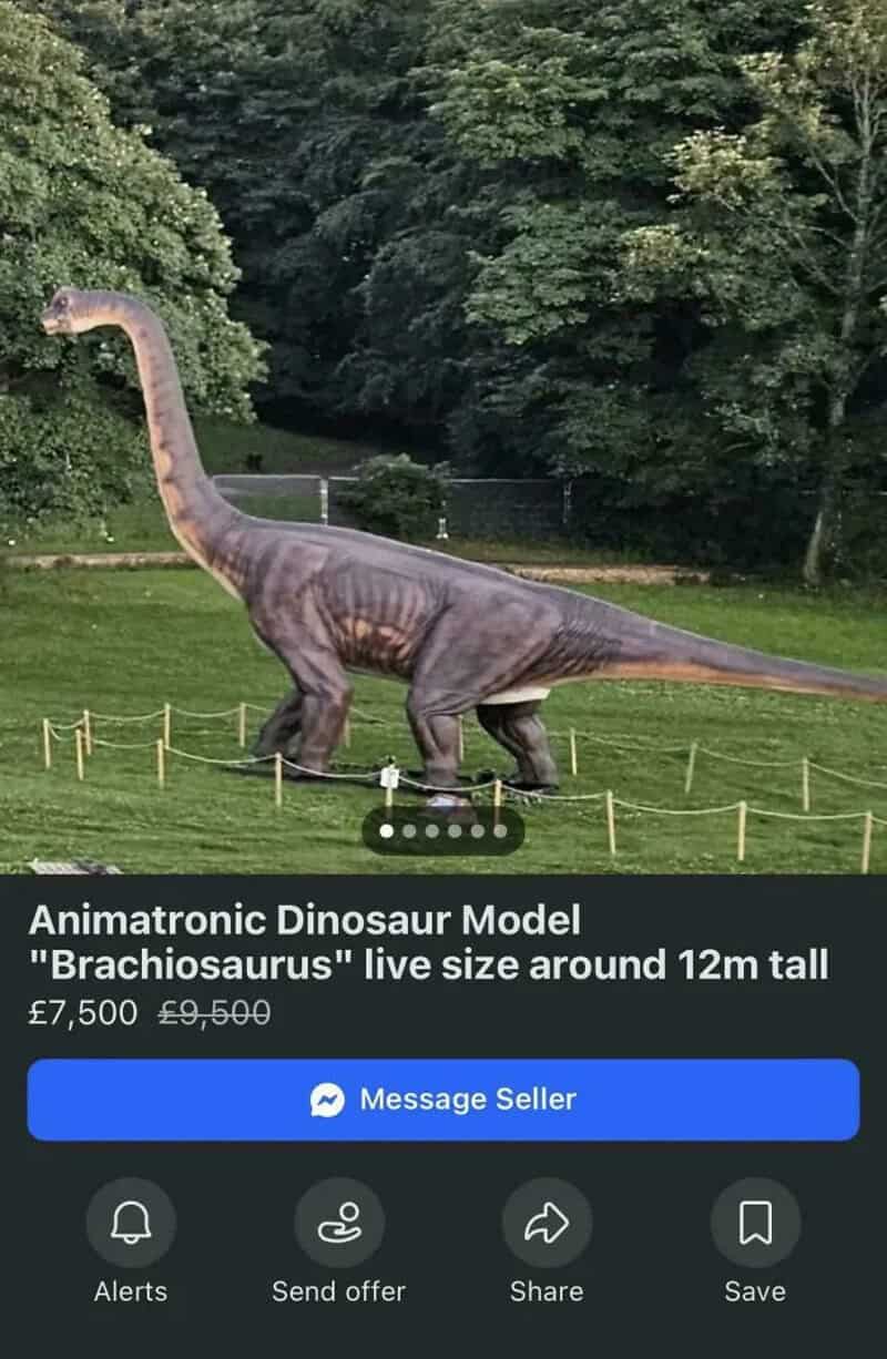 Large Brachiosaurus dinosaur model in a park with trees and grass.