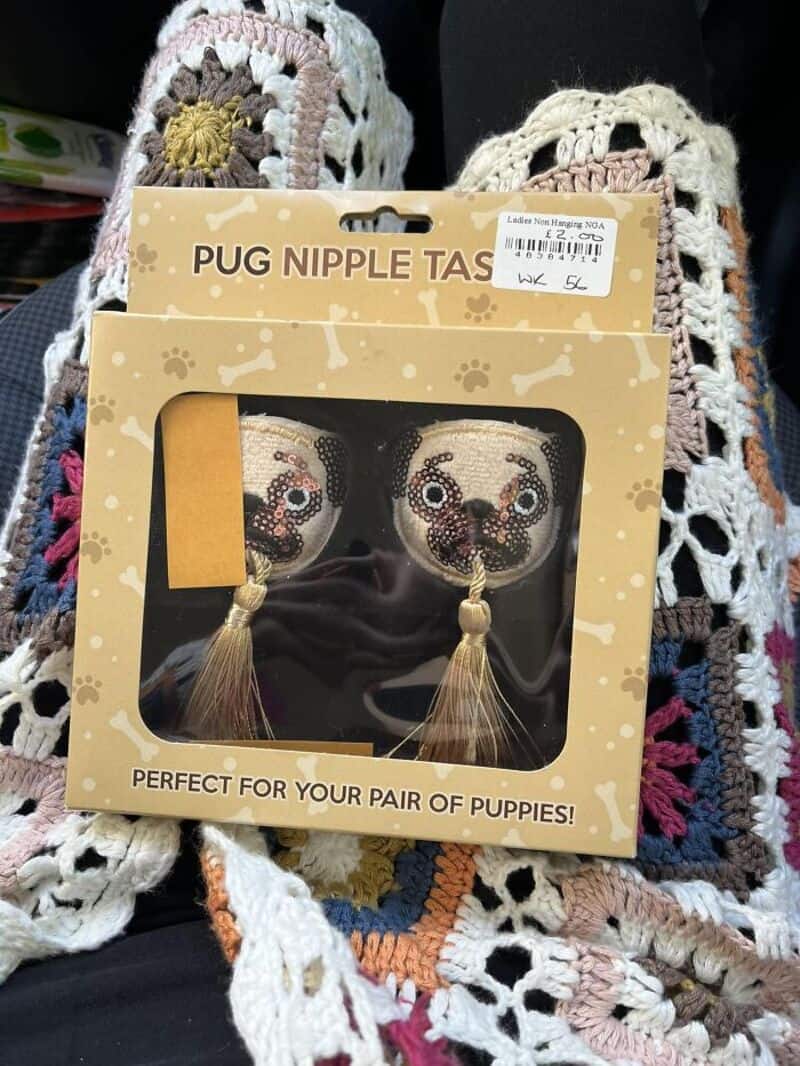 Pug nipple tassels on packaging with decorative crocheted background.