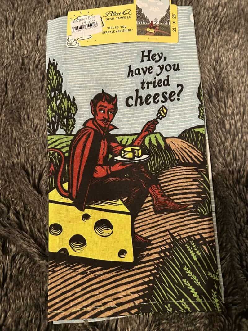 Hey, have you tried cheese? devilish figure on hill with cheese wedge.