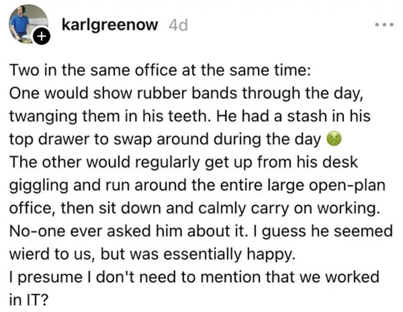 Two coworkers in an office, one with rubber bands in his mouth, the other running around.