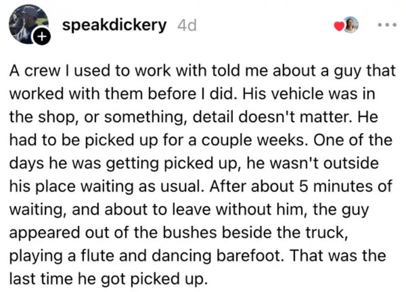 A man playing a flute and dancing barefoot beside a truck, waiting to be picked up.