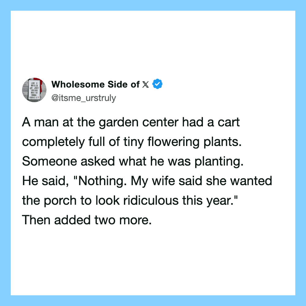 A man at the garden center with a cart full of tiny flowering plants.