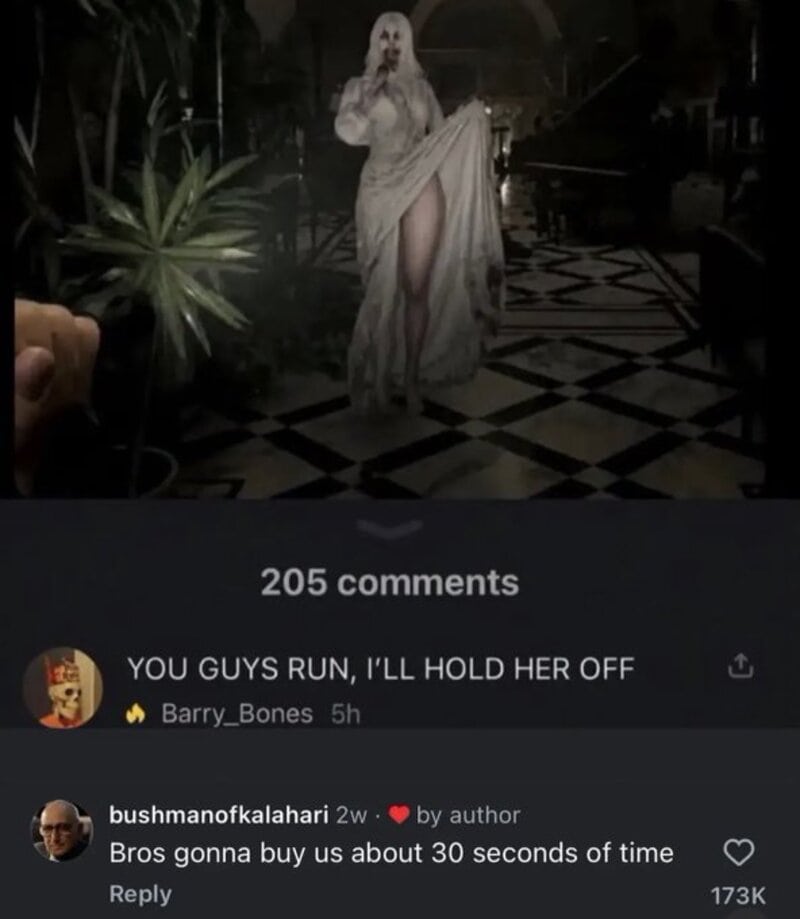 A person in a white dress with a mask, holding her dress to reveal her leg, in a dimly lit room.