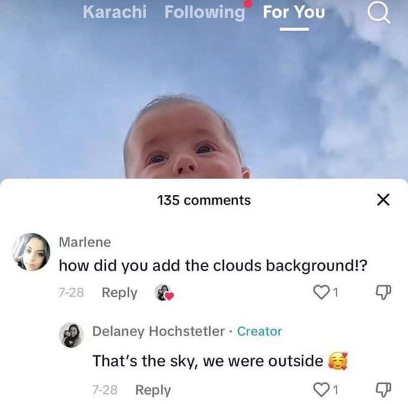 Child with clouds background, comments about the sky and outdoor setting.