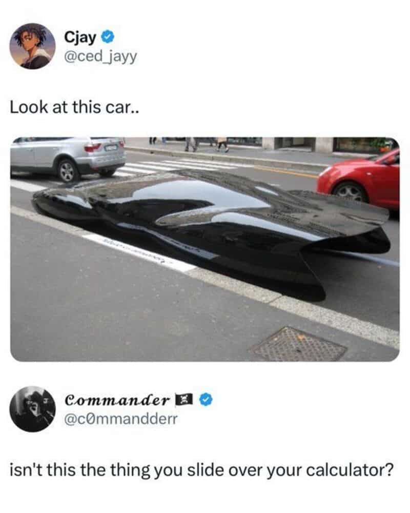 Black car with a sleek, futuristic design parked on the street.
