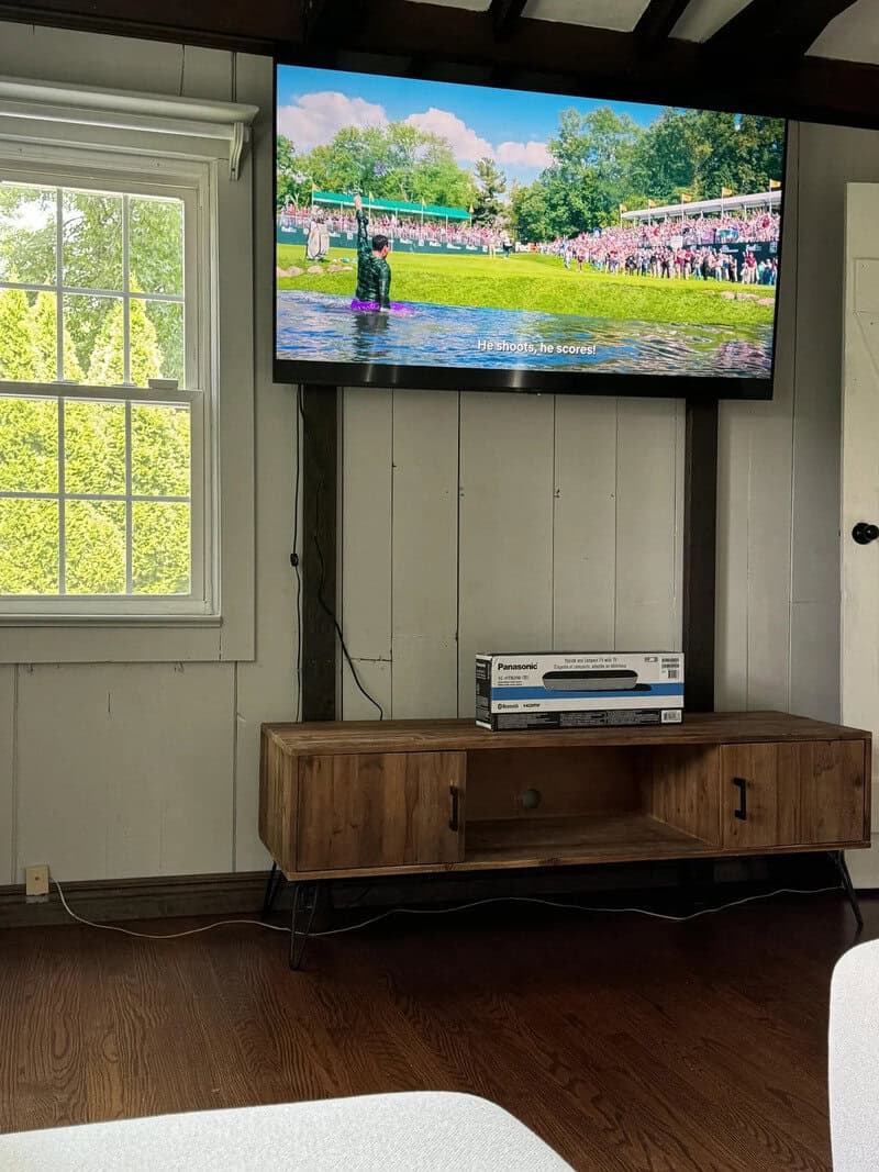 TV showing a scene of a person in a pond with a crowd watching.