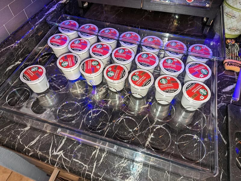Multiple containers of Arizona brand ice cream on a black marble countertop.