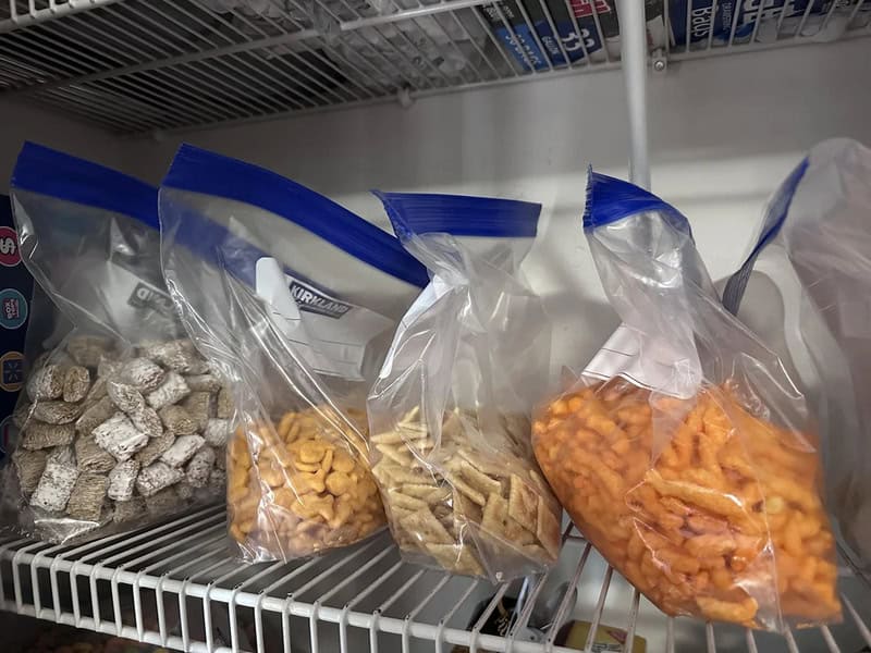 Assorted snacks in clear plastic bags on a shelf.